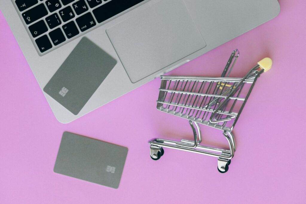Ecommerce Business Silver Shopping Cart On Pink Surface 
