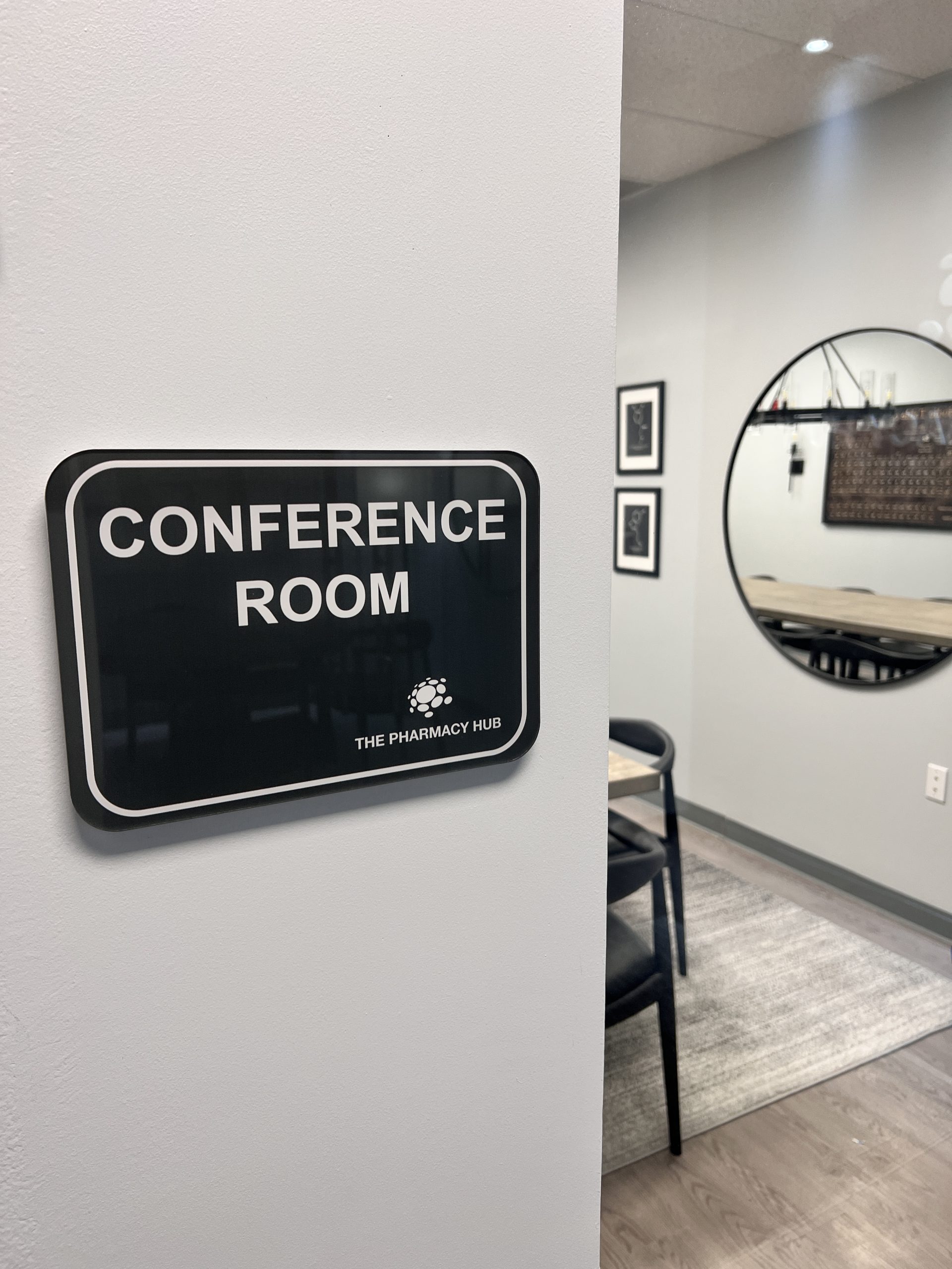 The Pharmacy Hub Pharmacy Signage In Miami Gardens Black Rounded-Corner Acrylic Conference-Room Plaque Mounted Beside A Glass Meeting Room