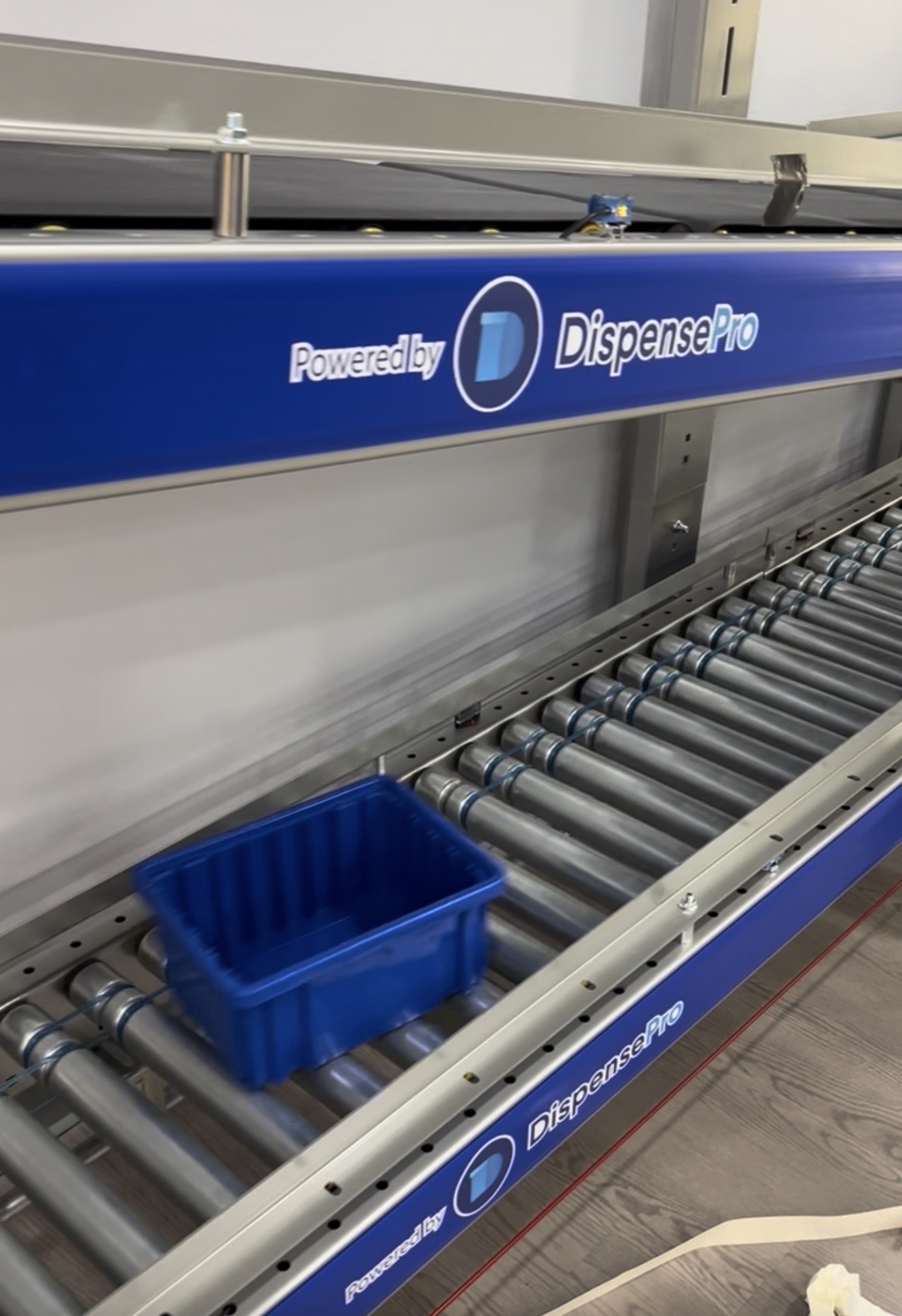 The Pharmacy Hub Pharmacy Signage In Miami Gardens Blue Printed Branding Decal Applied To A Pharmaceutical Fulfillment Conveyor