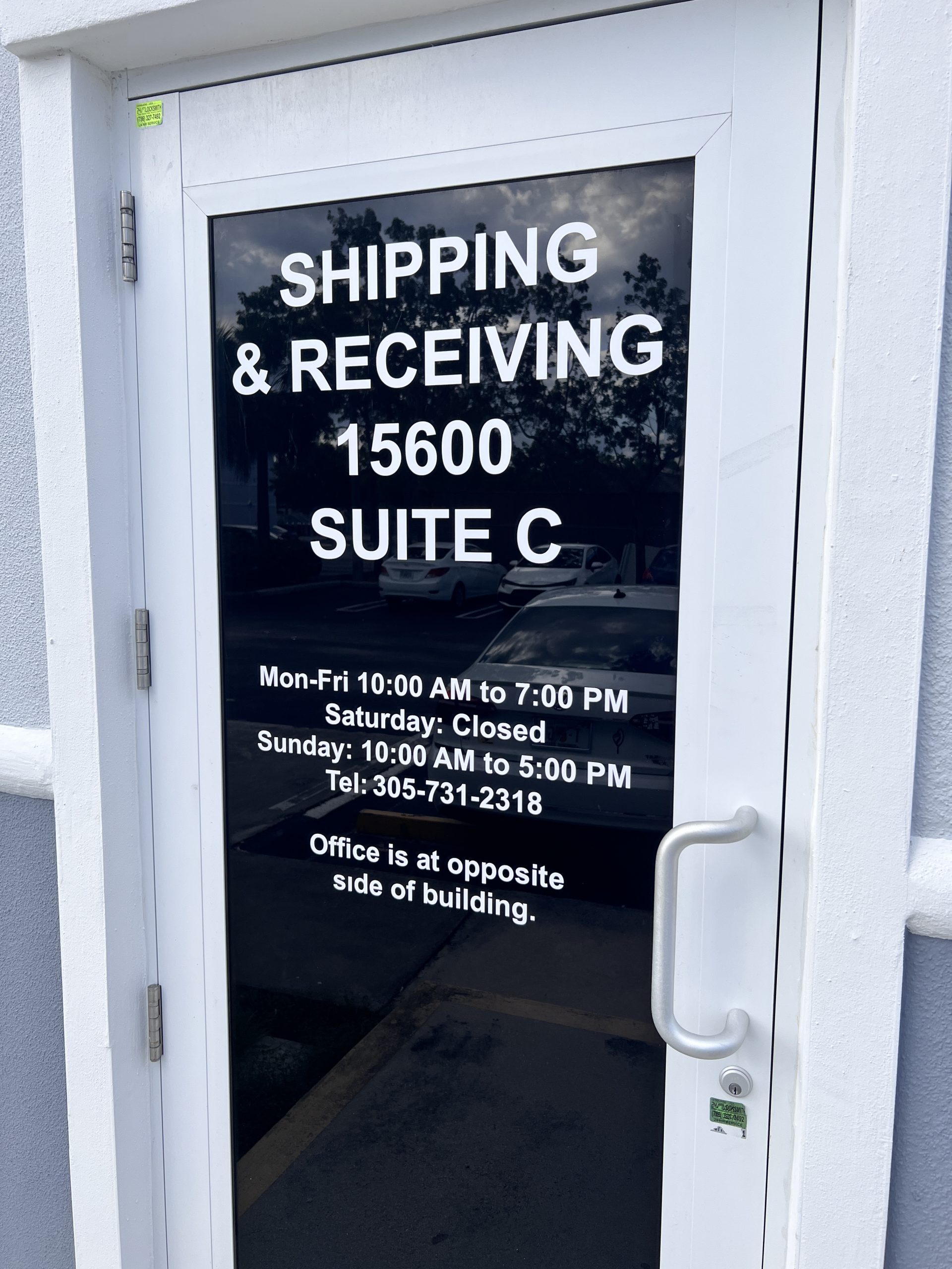 The Pharmacy Hub Pharmacy Signage In Miami Gardens Close-Up Of White Vinyl Shipping And Receiving Door Graphics On A Reflective Glass Door